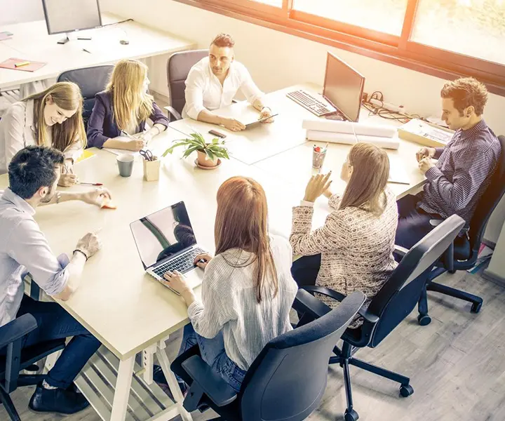 A group of people sitting around a table.