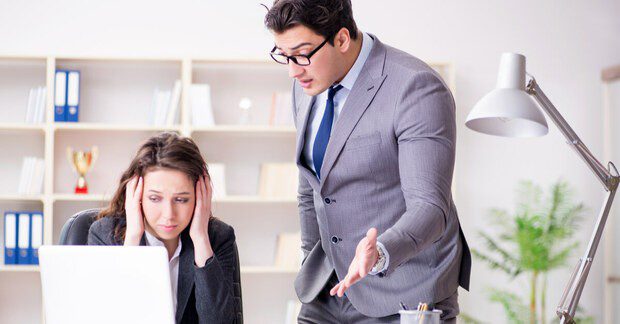 Man yelling at woman in office.