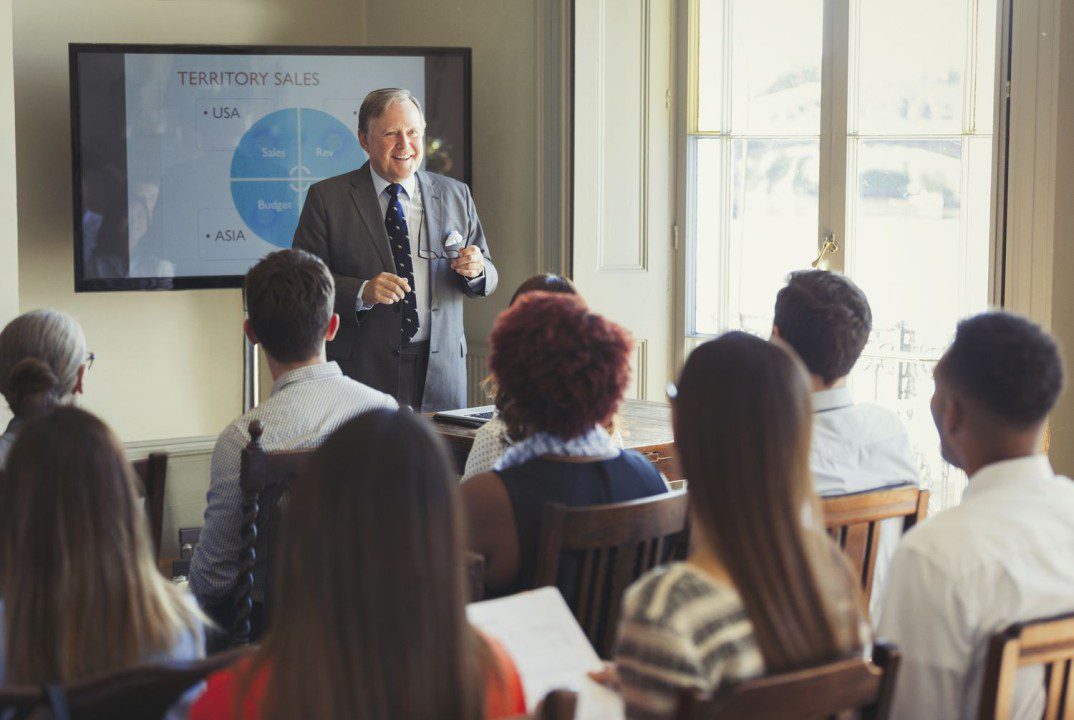 Businessman presenting sales data to colleagues.