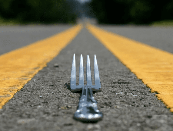 Fork on yellow lines on asphalt road.