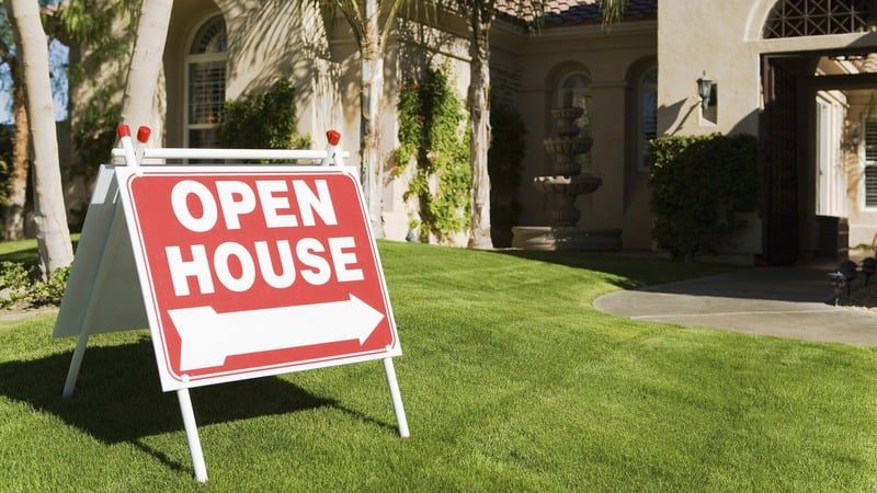 Open house sign in front of house.