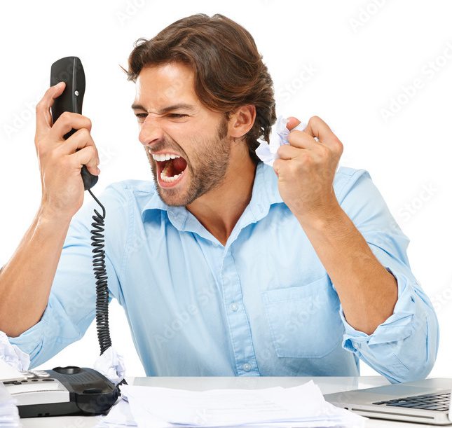 Angry man yelling on phone, crumpling paper.