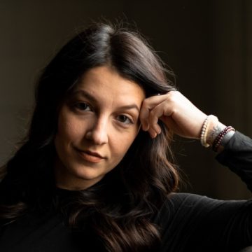 Portrait of a woman with dark hair.