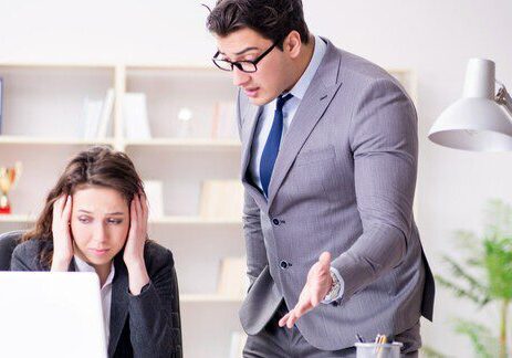 Man yelling at woman in office.