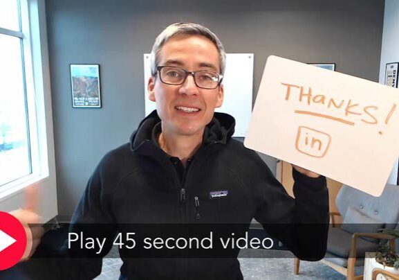 Man holding "Thanks! LinkedIn" sign.