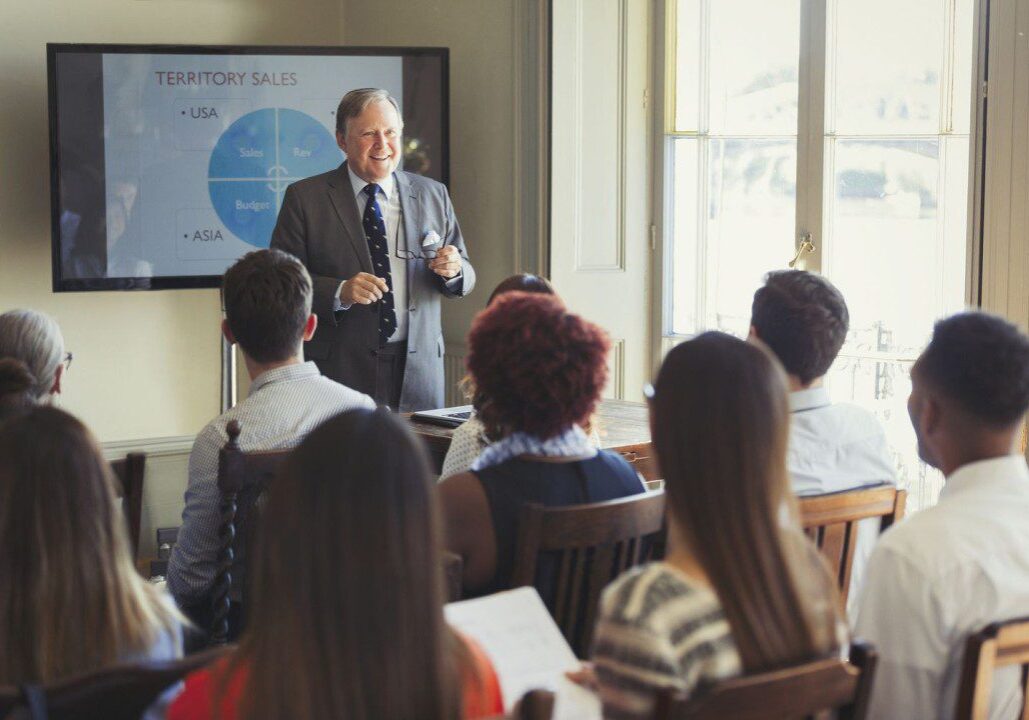 Businessman presenting sales data to colleagues.